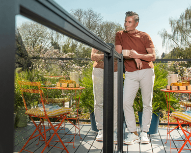Image Deck Railing Systems Category Person Enjoying A Drink While Leaning On Deck Railing 2X