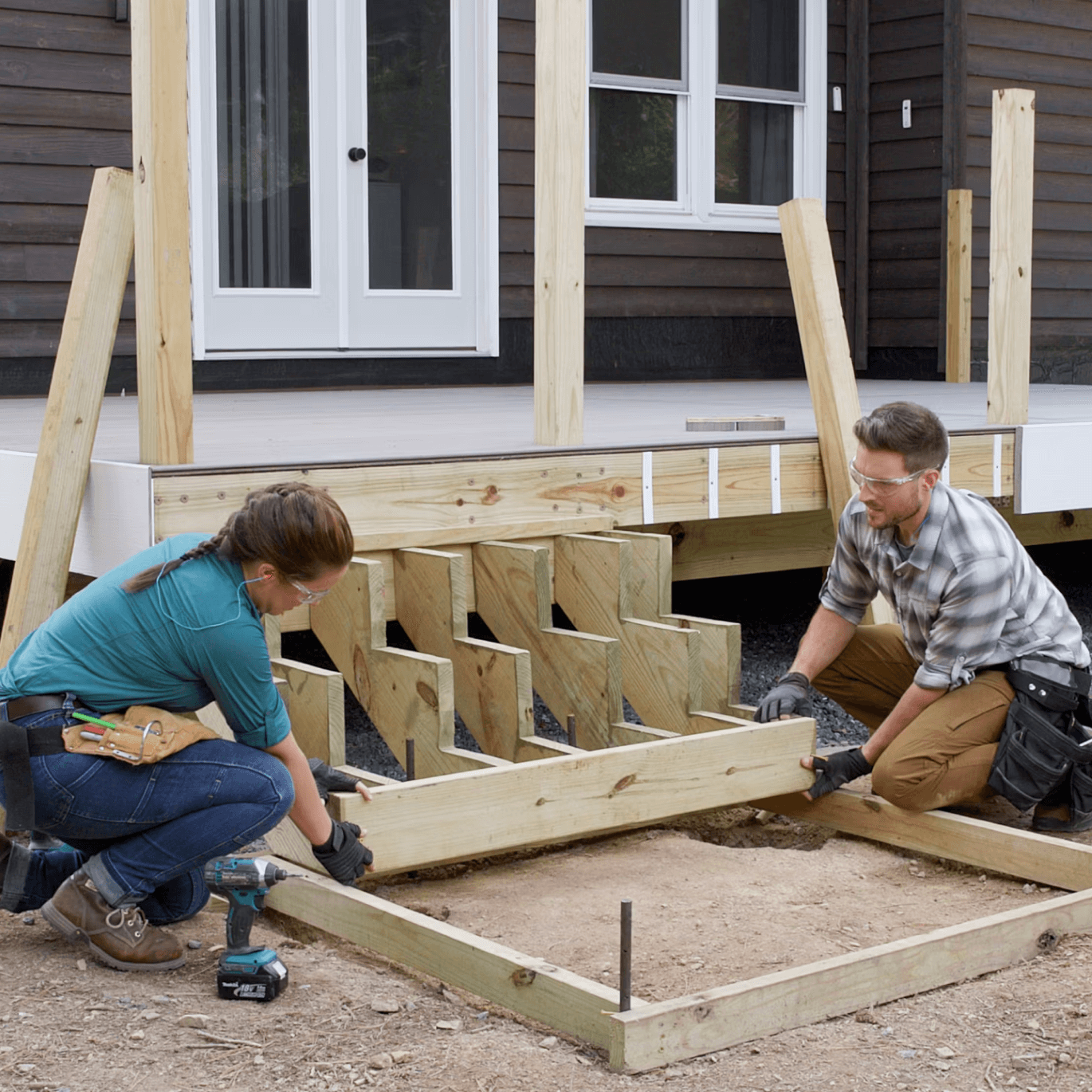 Image Two People Building A Deck