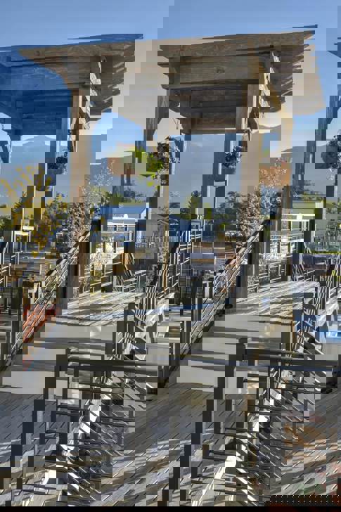 A walkway dividing a large yard with a pergola over the walkway