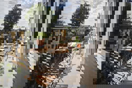 Balcony Patio With String Lights Draped On Deck Railing Showcasing Creative Balcony Lighting Ideas