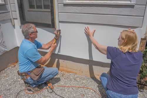 Slip the siding up and around the door