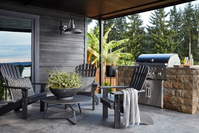 Small outdoor kitchen with a grill and seating for three