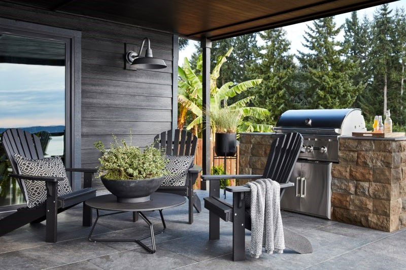 Small outdoor kitchen with a grill and seating for three