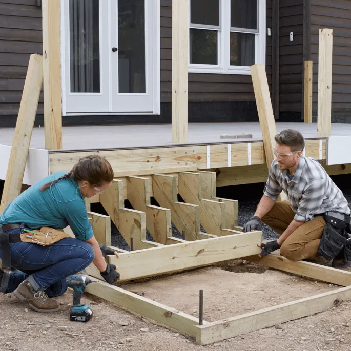Image Two People Building Deck Stairs