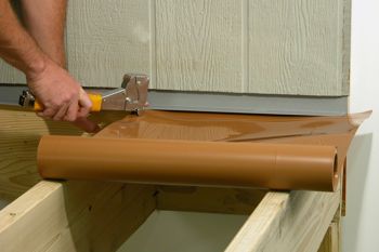 Tuck the trough under the flashing to the wall