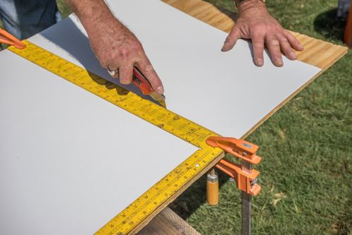 Score with a utility knife. Do not cut all the way through.