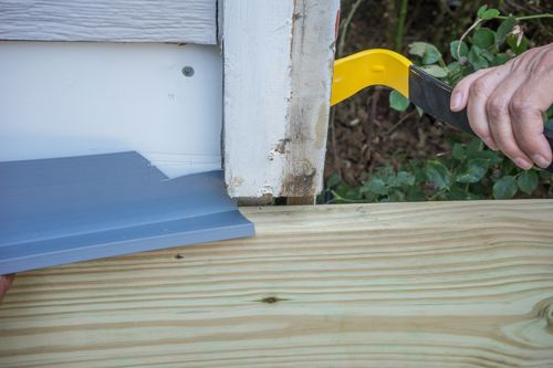 Slip the flashing behind the trim