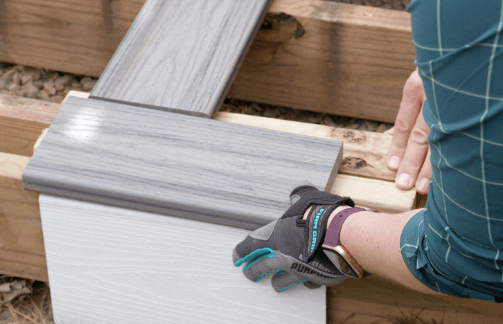 Person Installing Composite Deck Boards To Wood Framing