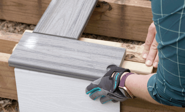Person Installing Composite Deck Boards To Wood Framing