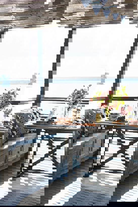 Patio on the beach shaded by a pergola