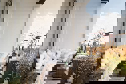 Patio With Quality Tile And Patio Furniture Surrounding Rug Emphasizing The Use Of Tile For Outdoor Spaces